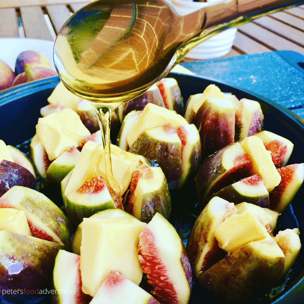 pouring honey over figs, ready for roasting