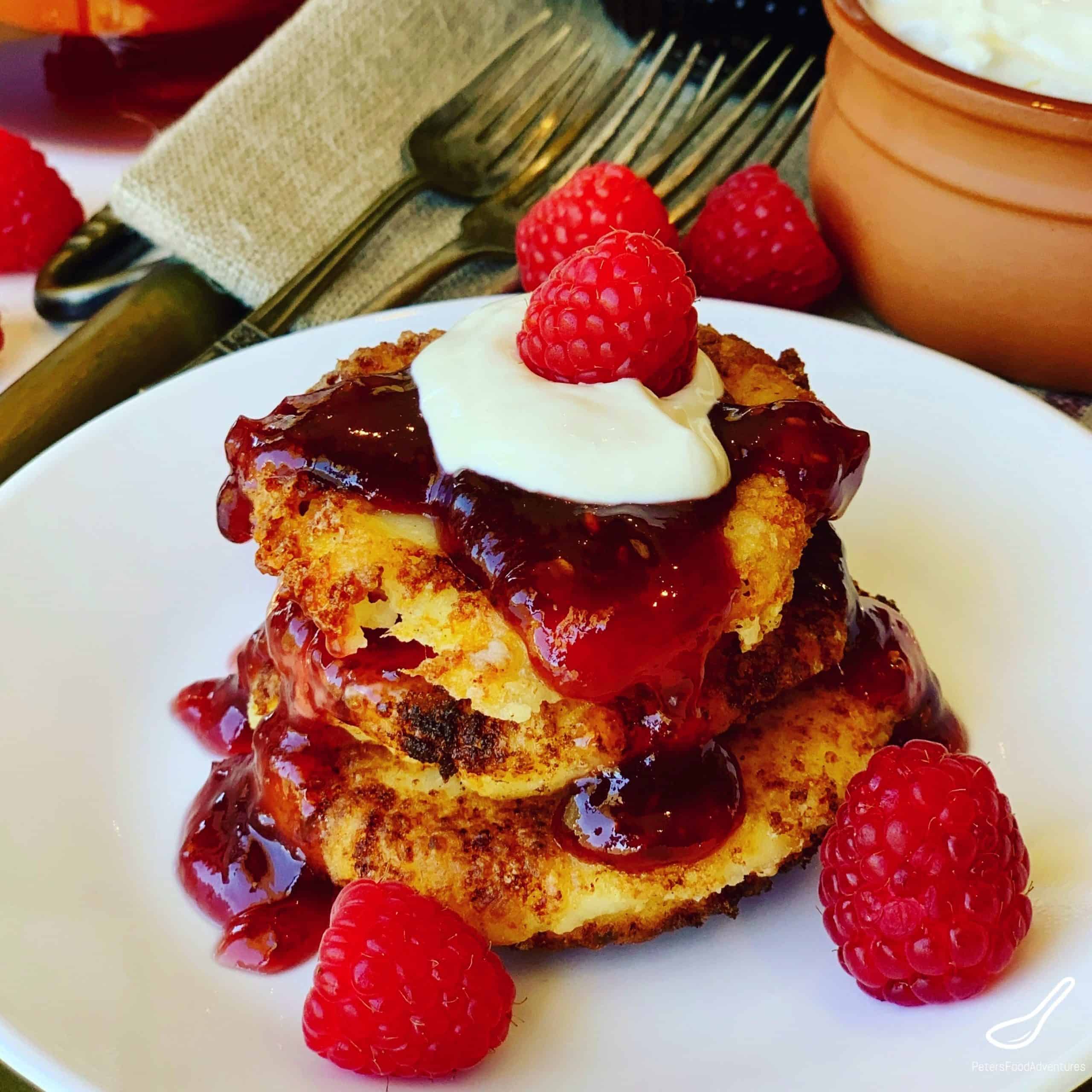 Babushka's Russian Syrniki, rustic, creamy and delicious. Made from Tvorog, Quark, or Farmers Cheese is a delicious Cheese Pancake. Crispy on the outside, creamy on the inside, topped with sour cream and jam. One of my favorite breakfast recipes.