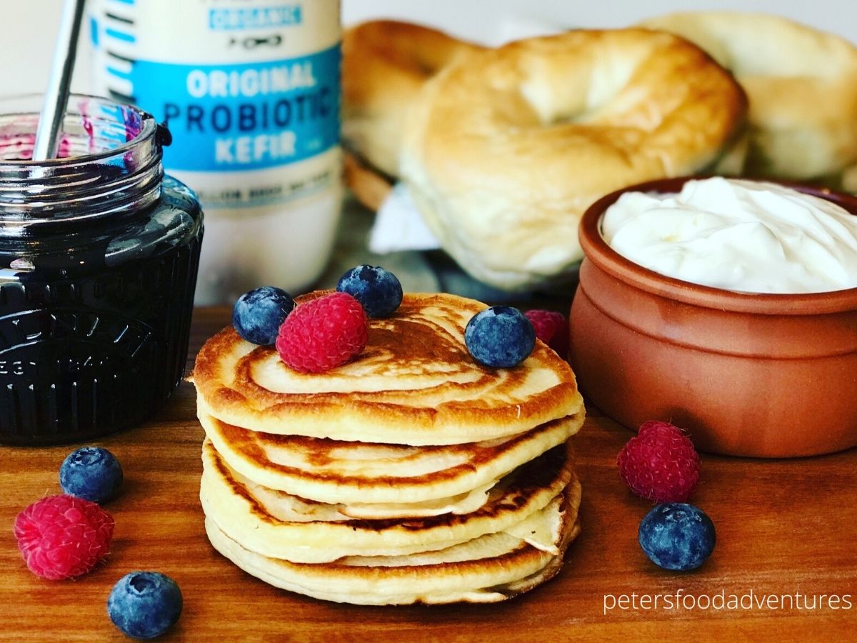 pancake stack with berries, jam and cream