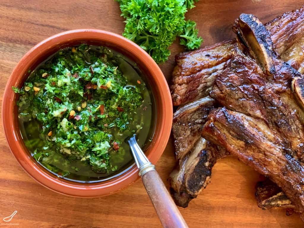 Chimichurri Green Sauce in a bowl next to bbq beef