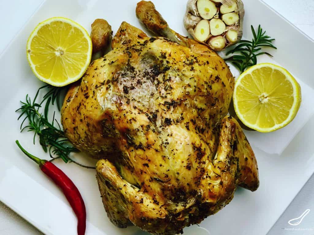 Juicy Whole Roasted Chicken, stuffed with lemon, garlic and rosemary. You won't go wrong with this easy chicken recipe that's baked upside down for maximum flavor.