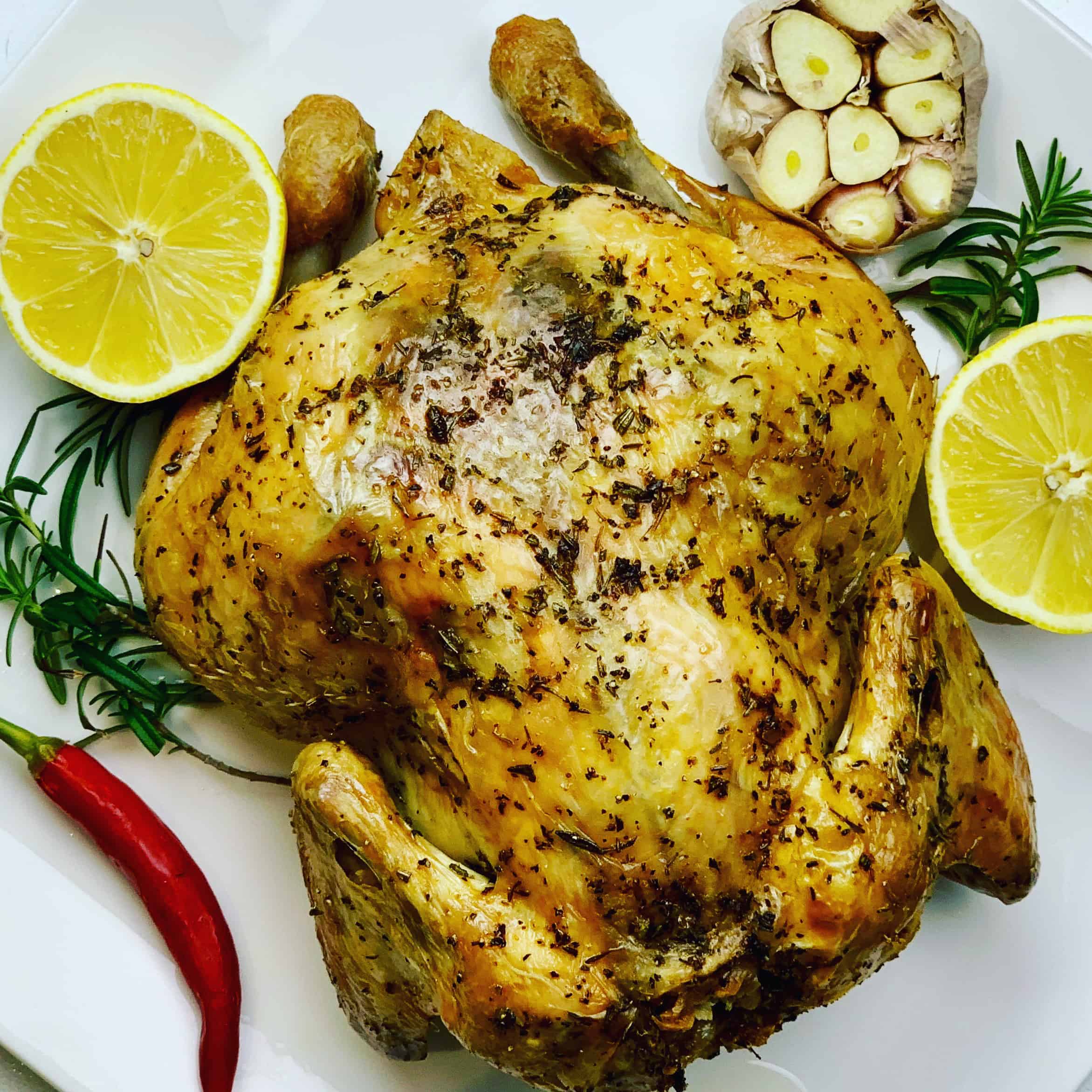 Juicy Whole Roasted Chicken, stuffed with lemon, garlic and rosemary. You won't go wrong with this easy chicken recipe that's baked upside down for maximum flavor. Winner Winner Chicken Dinner!