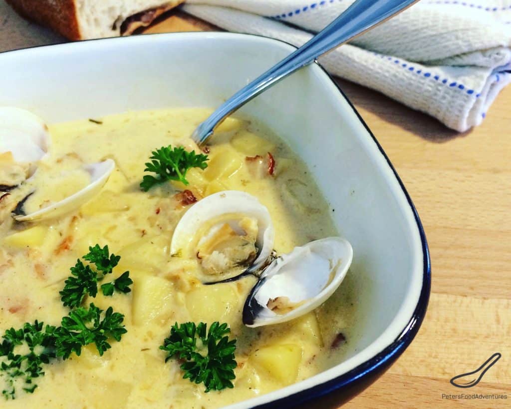 New England Clam Chowder in a bowl with fresh clams