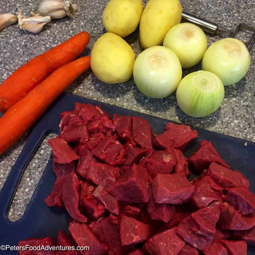 chopping meat for kavardak with onion, potatoes and carrots