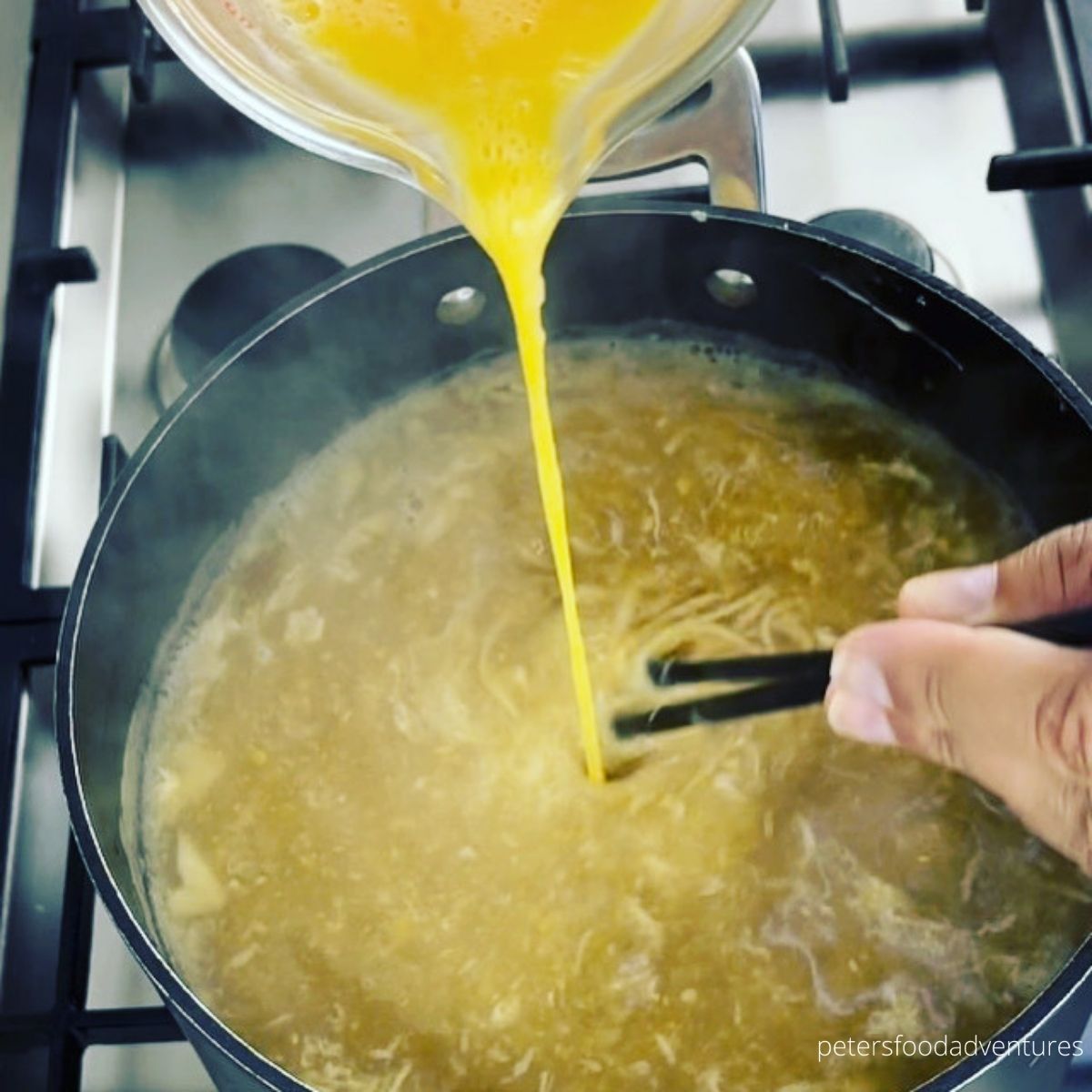 pouring egg ribbons into soup