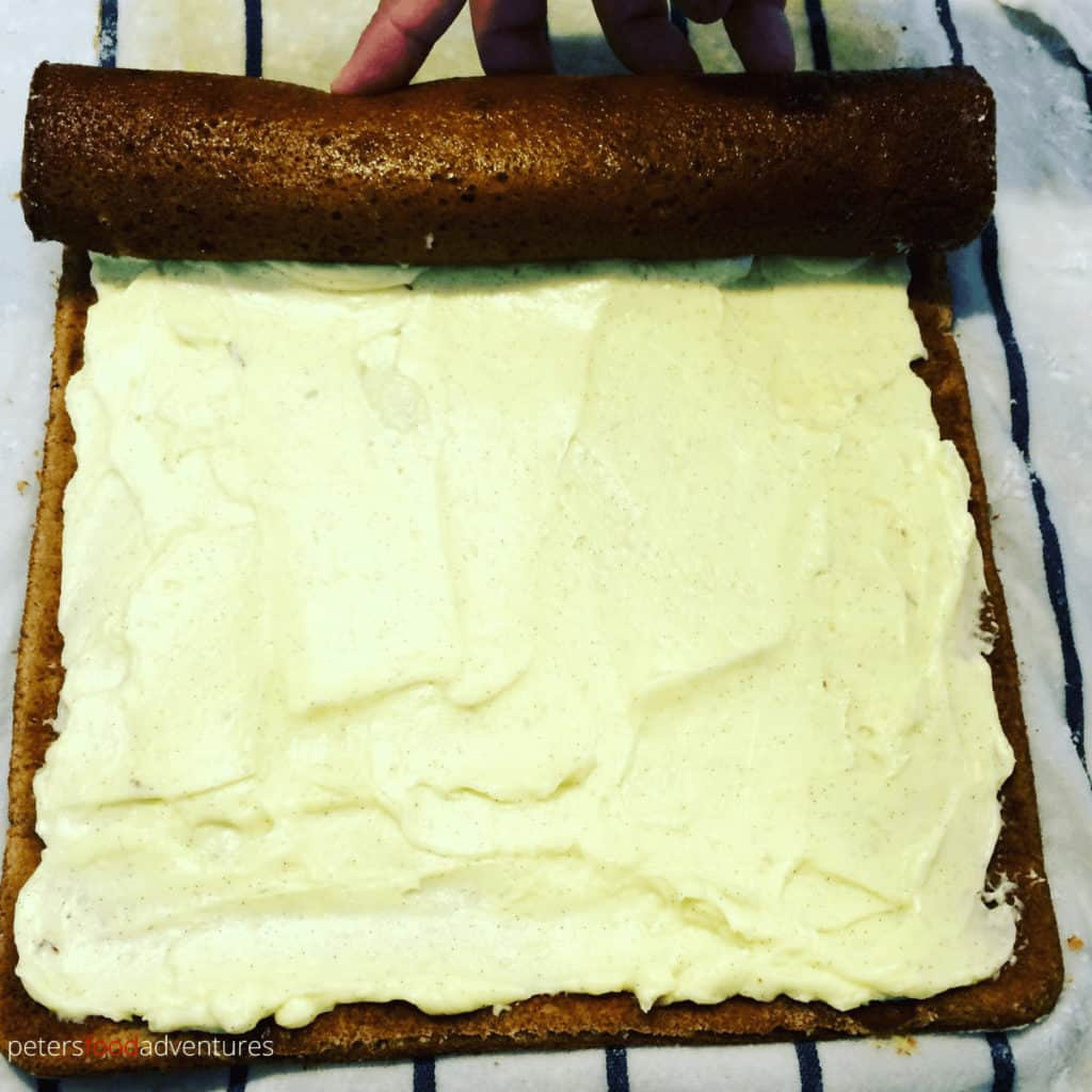 rolling a pumpkin roll with cream cheese