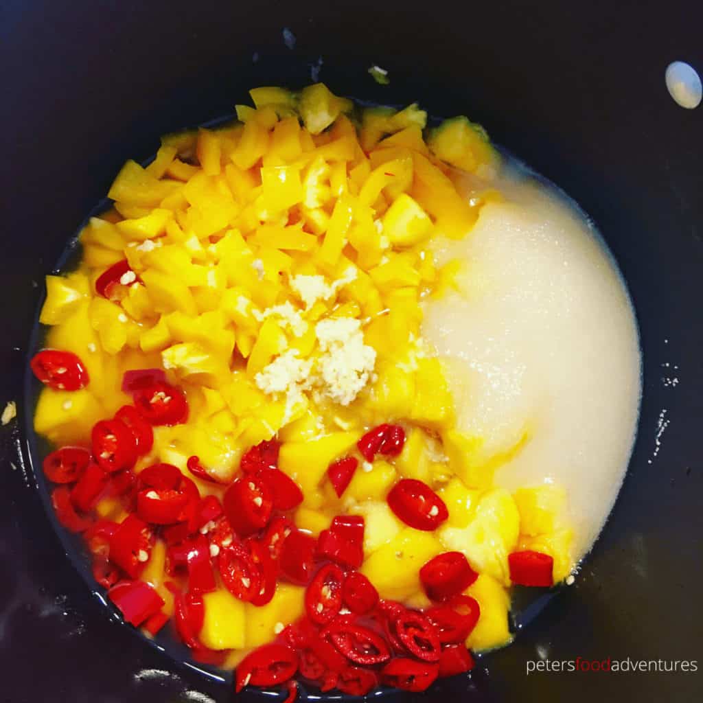 making mango chili sauce in a pot