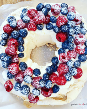 Berry Pavlova Wreath is perfect for the Christmas holidays or just to eat on a summer's day, with fresh blueberries and raspberries. Pavlova with berries is an Australian classic.