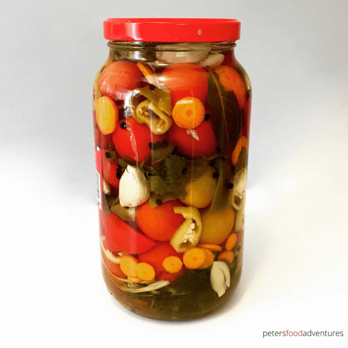 Enjoy your fresh, garden tomatoes by preserving them Russian-style. Pickled Tomatoes (солёные помидоры) with garlic and fresh herbs. I stuff extra vegetables between the tomatoes to make pickled vegetables too. These canned tomatoes are a staple year round.
