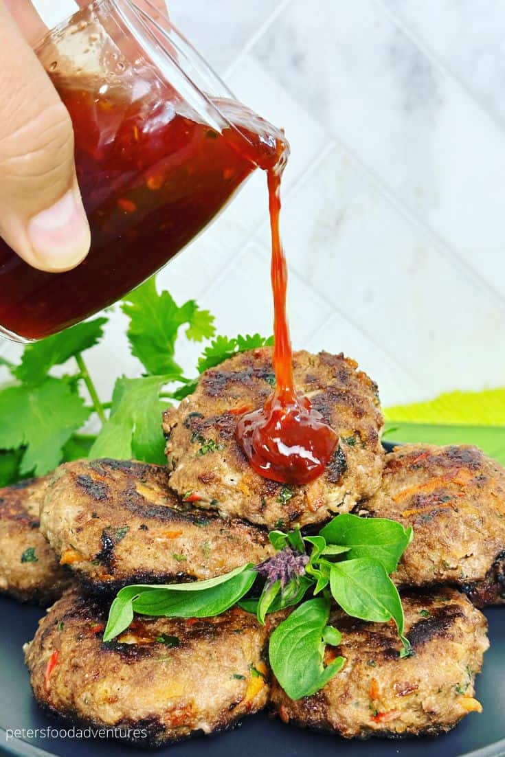 pouring sauce over rissoles