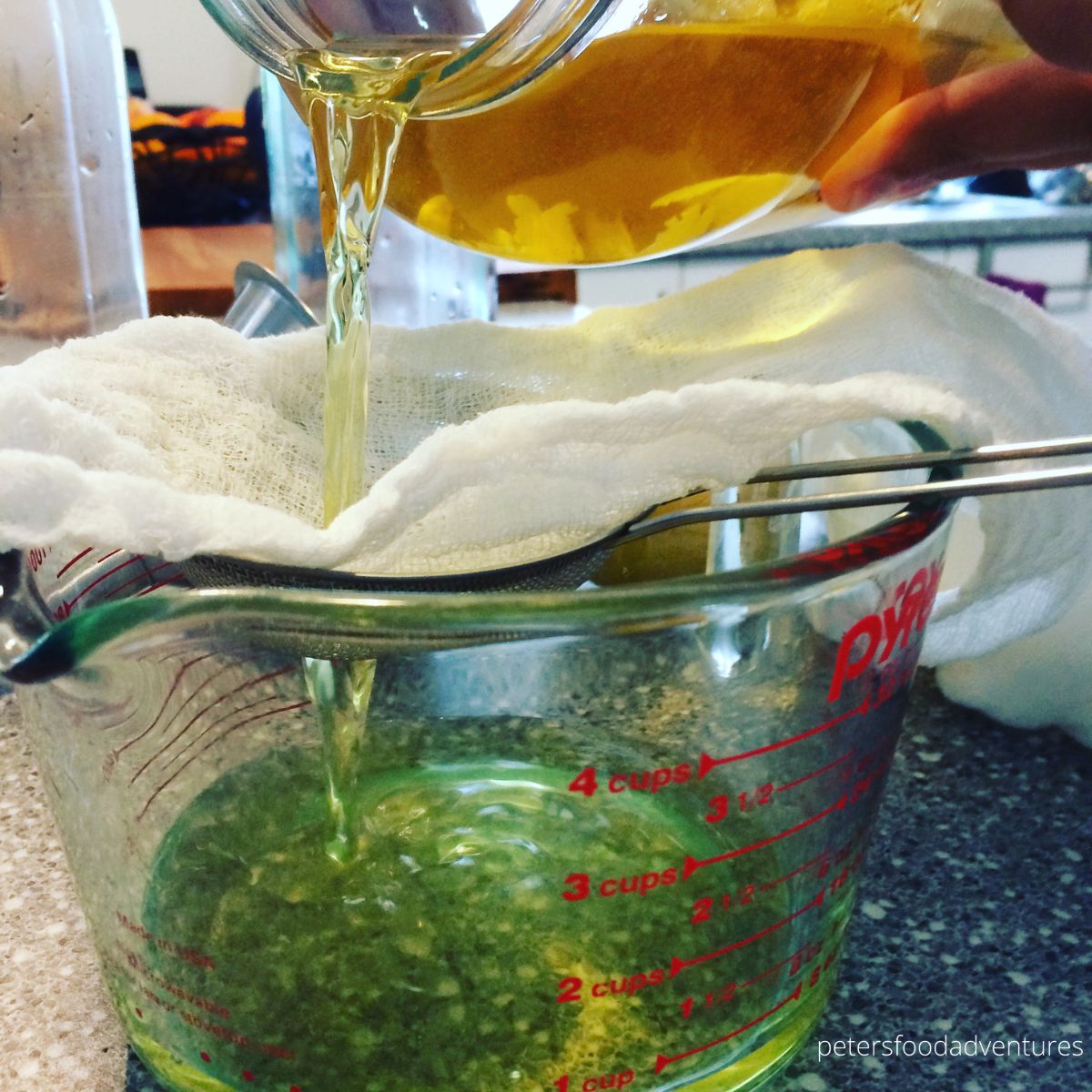 straining lemon vodka through cheesecloth