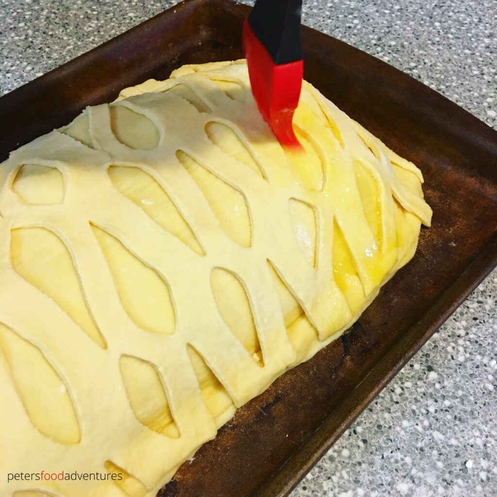 brushing egg wash dough