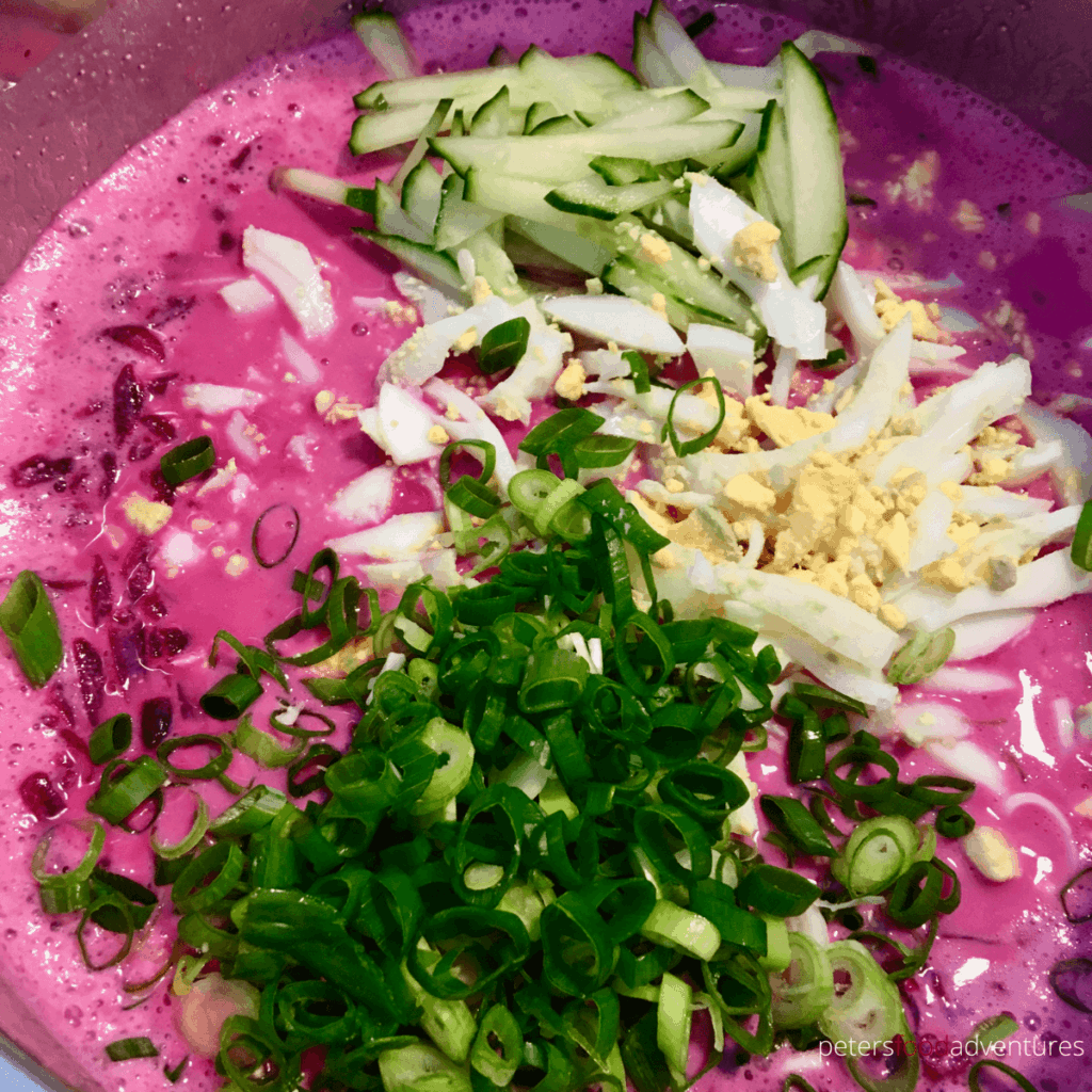 mixing holodnik soup ingredients together to make a pink soup