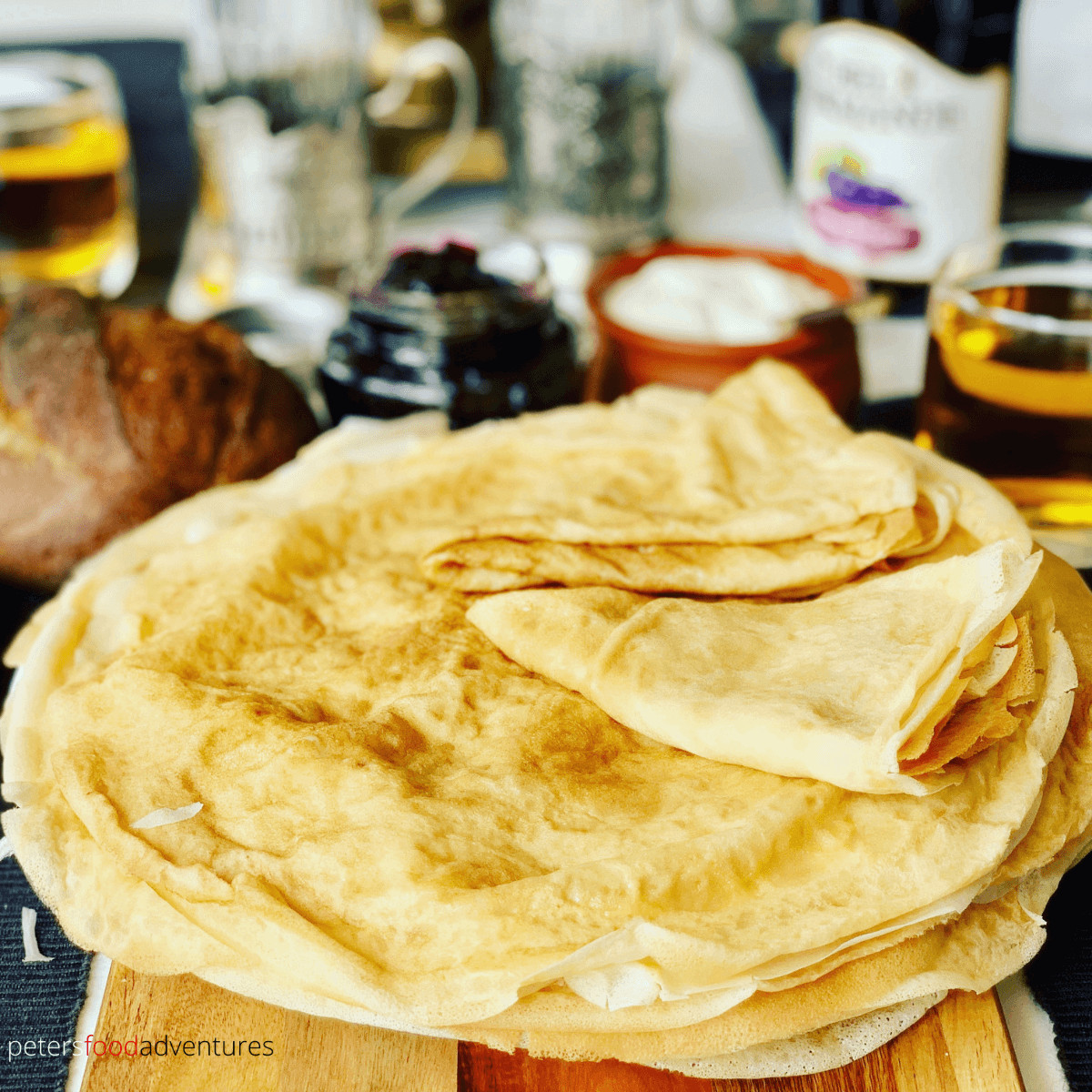 These Russian Pancakes commonly known as Blinchiki, Crepes, Blintzes or Blini are a staple food in Slavic countries. Often they are stuffed and rolled. I love eating them with butter, sour cream and blueberry jam. This is my lower fat blini recipe. Easy and delicious Russian Crepes or Blini Recipe (Блины)