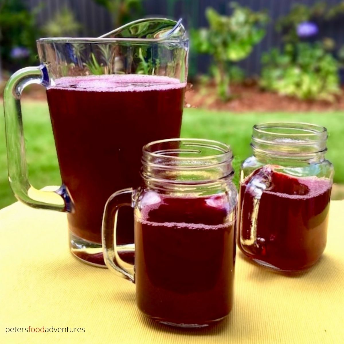 pitcher of berry juice with glasses
