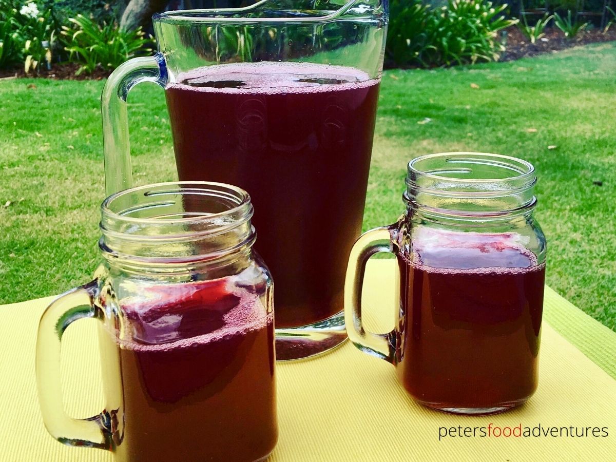 pitcher of berry juice with glasses