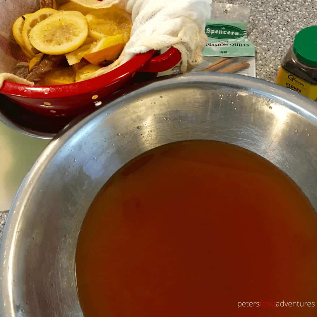 making russian tea, straining the citrus slices