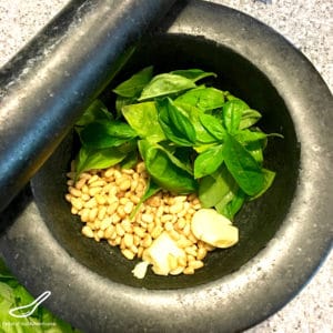 Fresh Basil and Pine Nuts in a Mortar and Pestle