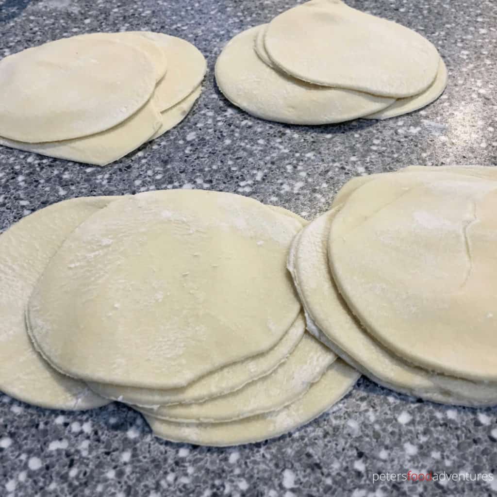 stacks of dough circles for making manti dumplings