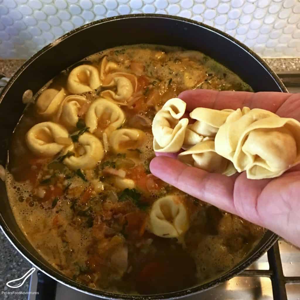 dropping tortellinis into a soup pot