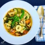 Easy Chicken Tortellini Soup with bacon and fresh basil. Delicious and hearty and loaded with vegetables. It's like a next level Minestrone Soup.