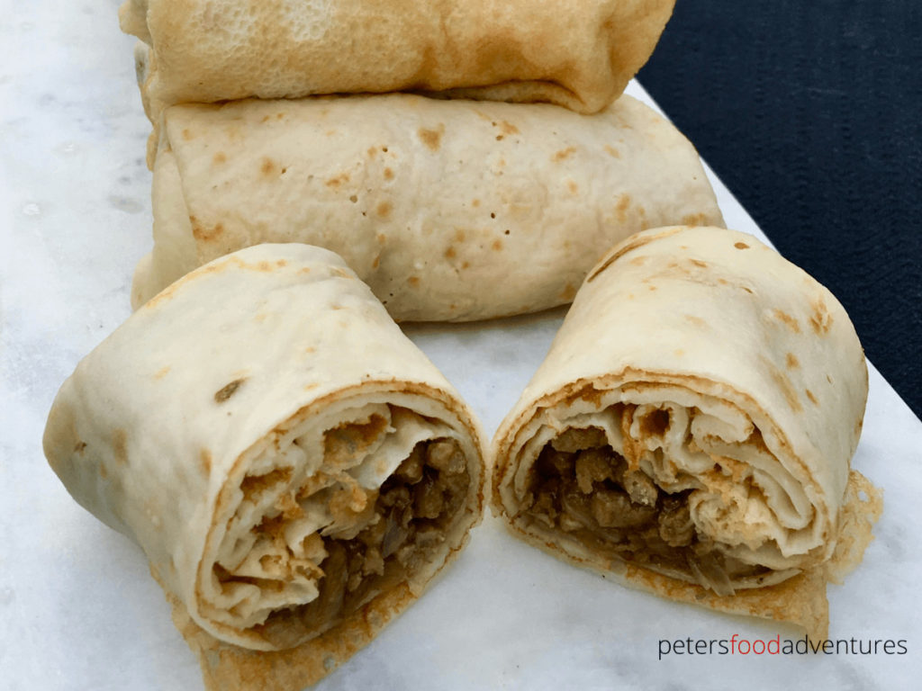 Russian Stuffed Blinchiki, also called Russian Crepes, are a thin rolled pancake stuffed full of savory meaty goodness. Not dry, fully of flavor and juicy. Meat Blini (Блинчики с мясом)