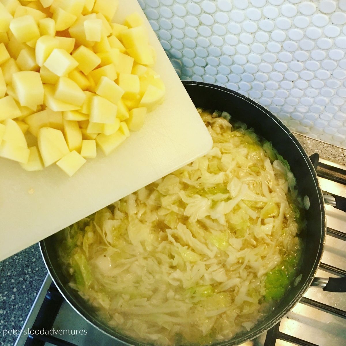 placing potatoes into a pot of soup