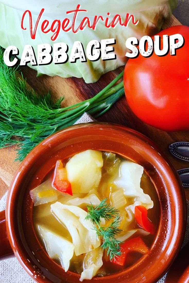 vegetarian cabbage soup in a bowl surrounded by vegetables