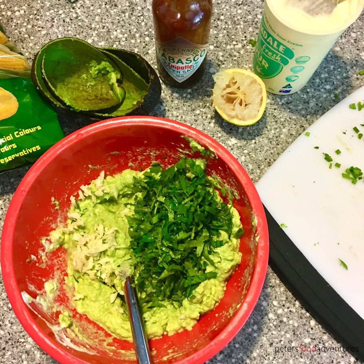 making guacamole bowl with cilantro