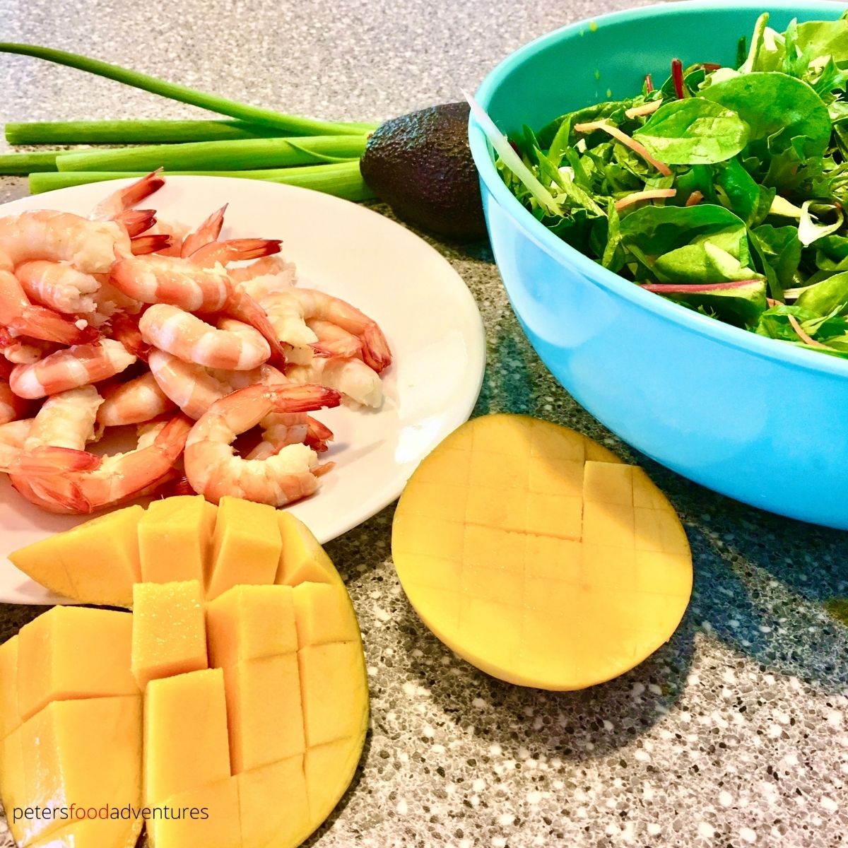 cut mango with shrimp on plate