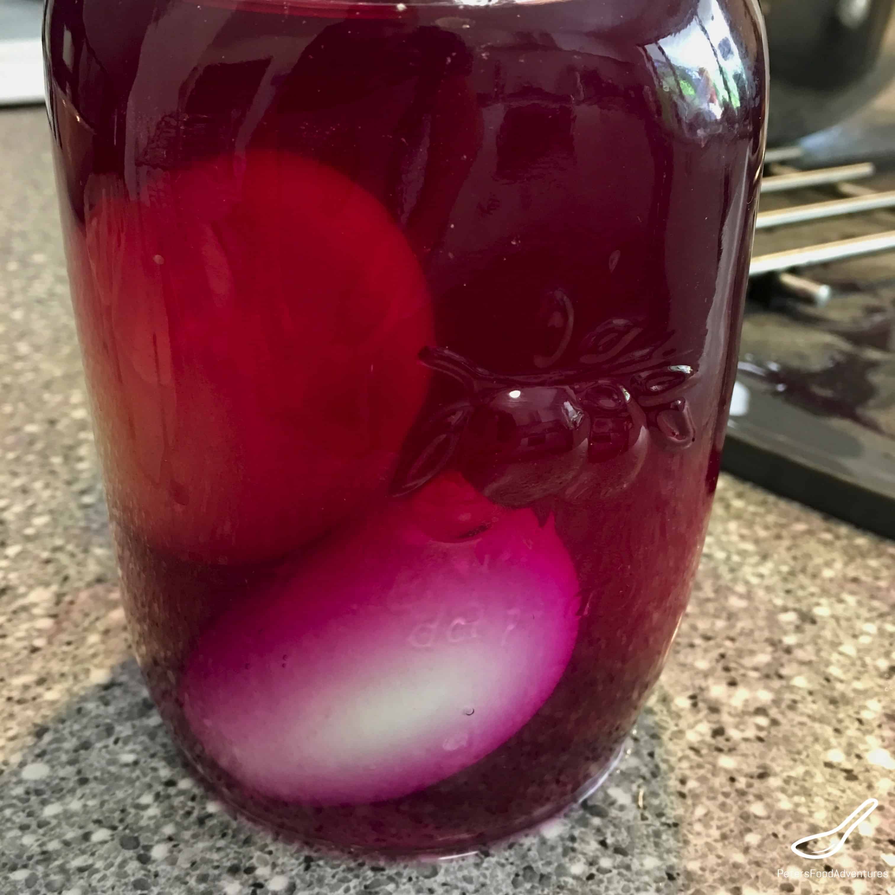 Making Easter Eggs - White eggs in red cabbage dye solution