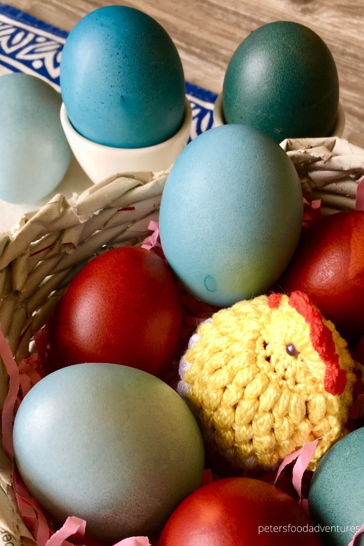 blue and red easter eggs in basket