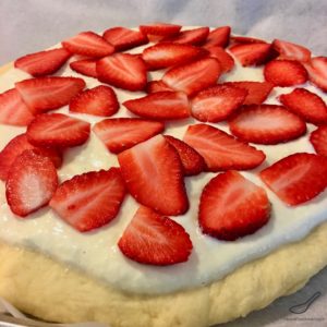A baked brioche style yeast bun generously smothered with sweet Tvorog, Farmer's Cheese or Quark and baked with fresh strawberries. Russian Pastry Sweet Bread Dessert (Сдобный пирог)