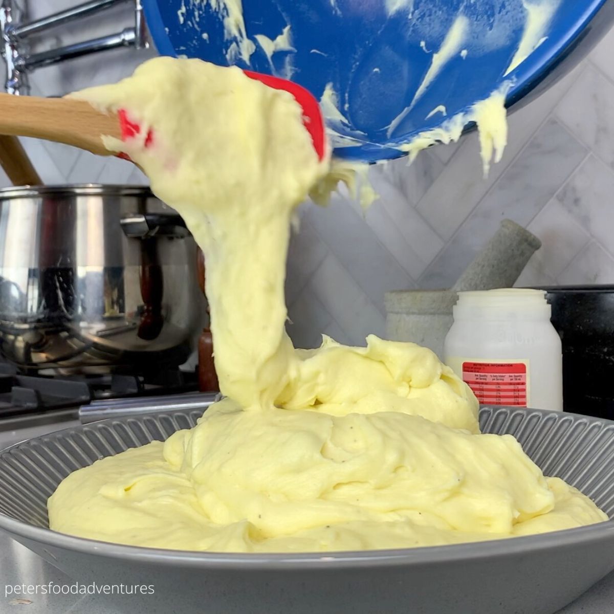 pouring mashed potatoes into bowl