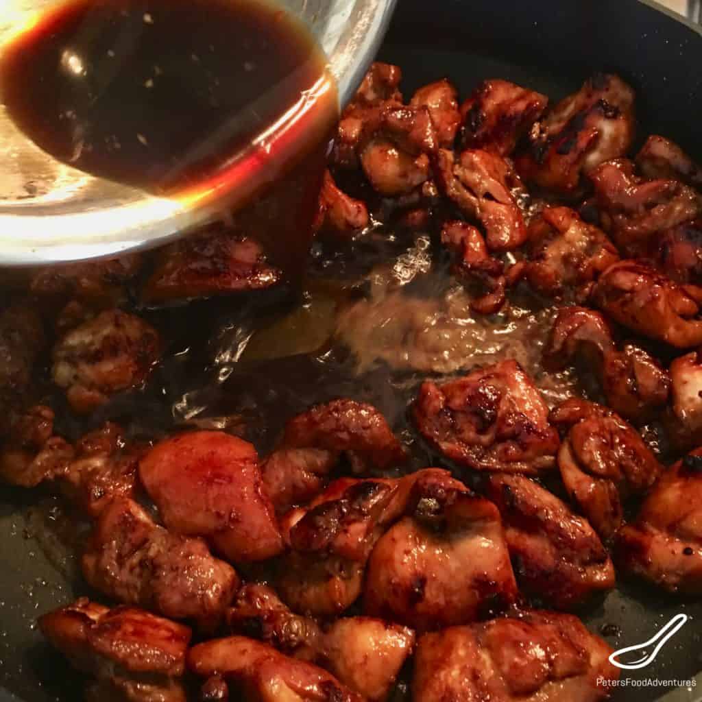 chicken teriyaki sauce pouring over chicken pieces to marinate