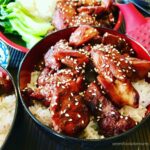 bowl of teriyaki chicken over rice