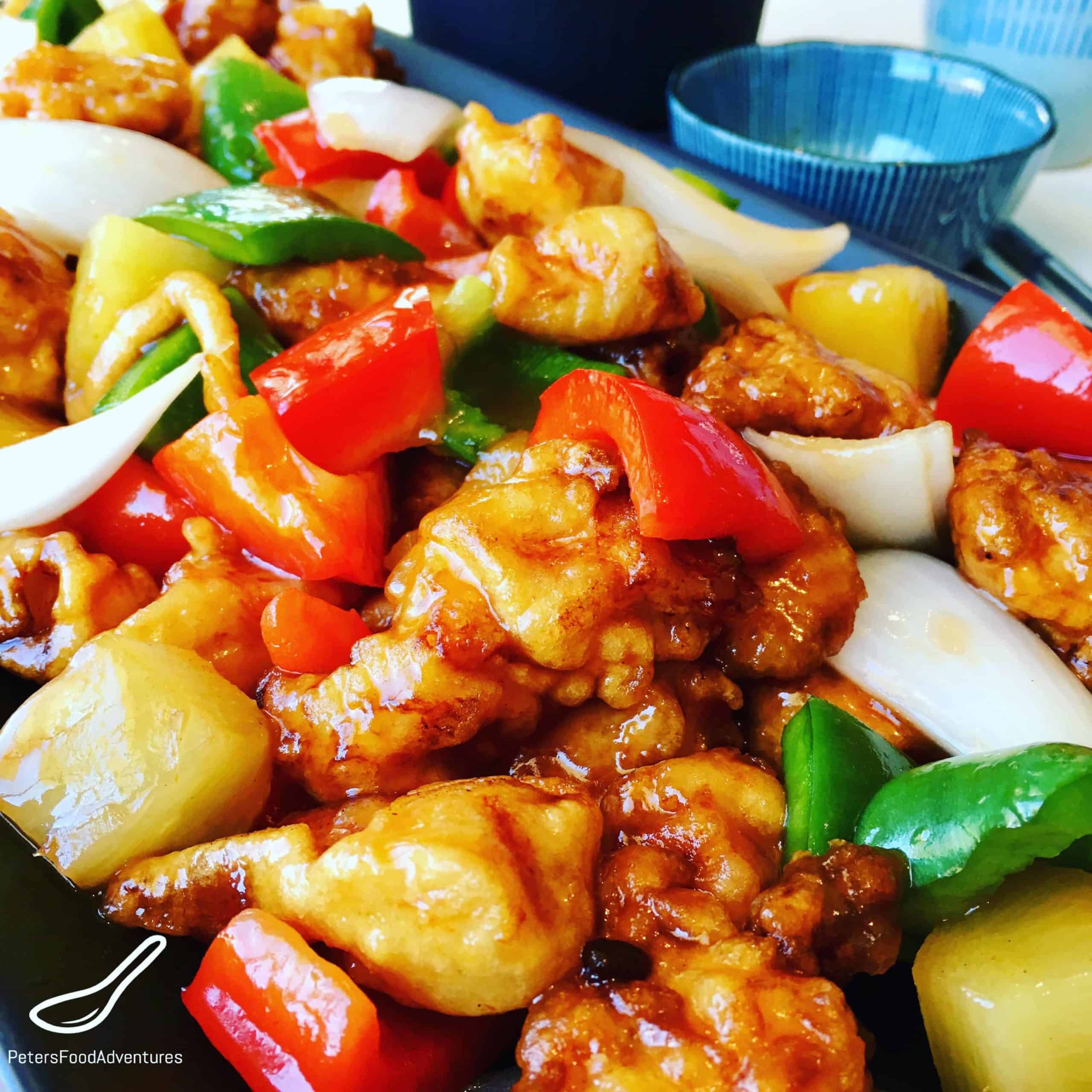 Boneless Sweet and Sour Pork in a crispy batter, food court style. The sauce is so easy to make with the sweetness of pineapple, bell peppers and onion. Tastes just like take out!