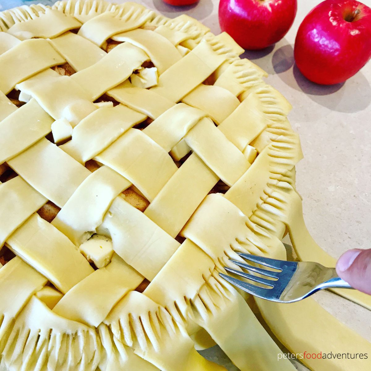 sealing apple pie with fork