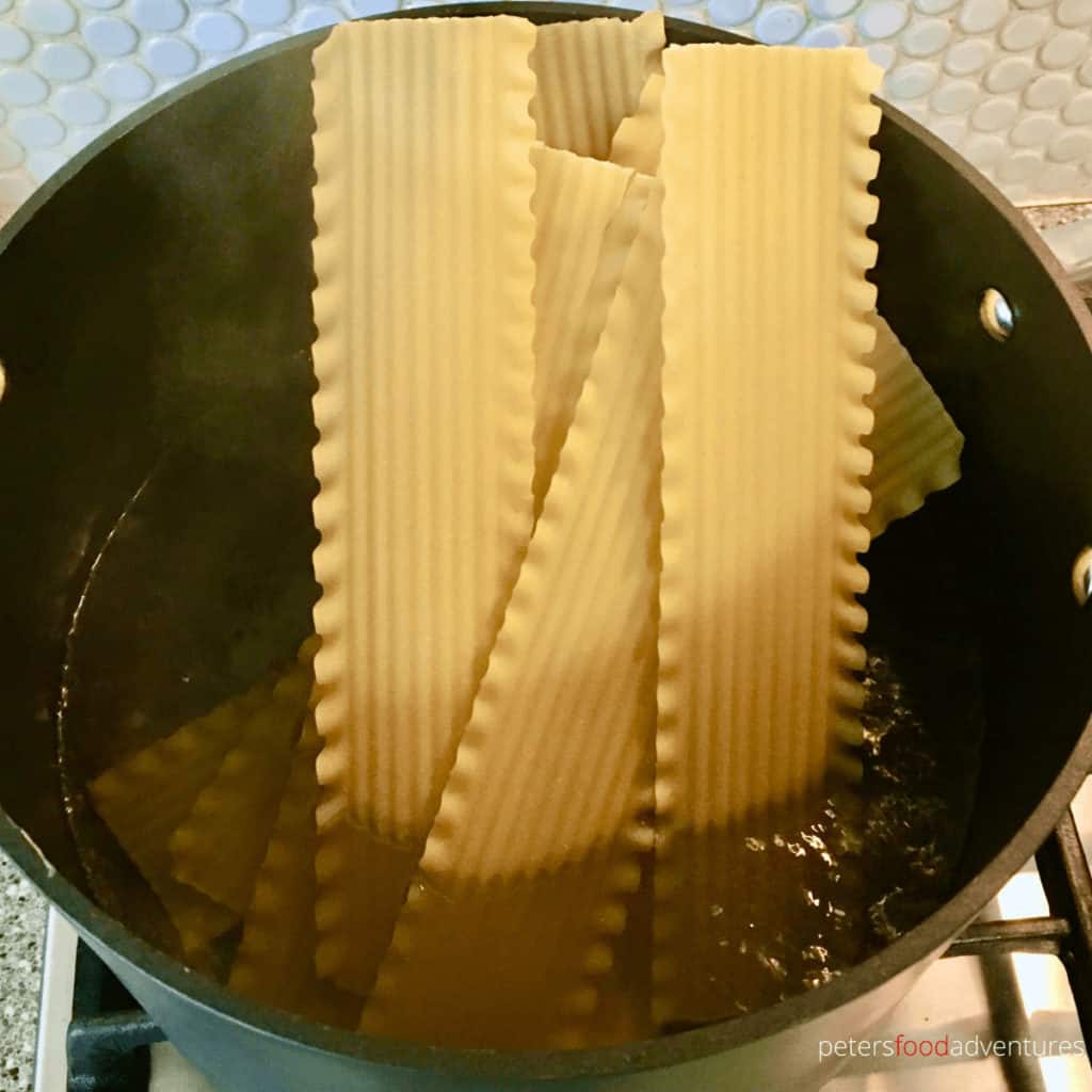 boiling lasagna sheets in a pot of water