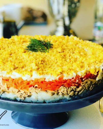 You have to try this Mimoza Salad (Мимоза)! A delicious Russian layered salad popular during celebrations and holidays. A hearty salad with Tuna, Potatoes, Carrots, Eggs and of course, lots of Mayo. Who needs regular potato salad when you can have Mimoza!