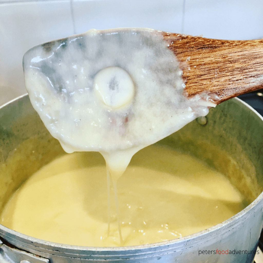 melted cheese dripping off a wooden spoon