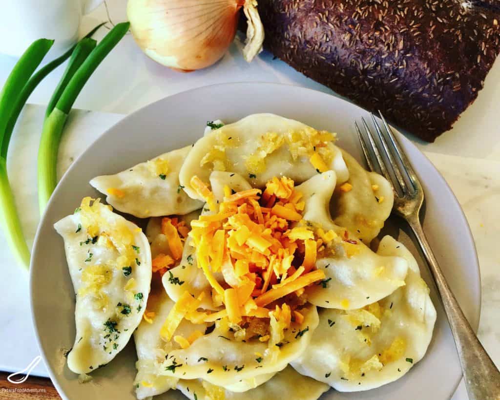 This Potato Cheddar Pierogi Recipe is a Canadian and American Classic dish with roots in Poland and Eastern Europe. Boiled or fried, served with sour cream, Potato and Cheddar dumplings, the perfect comfort food!