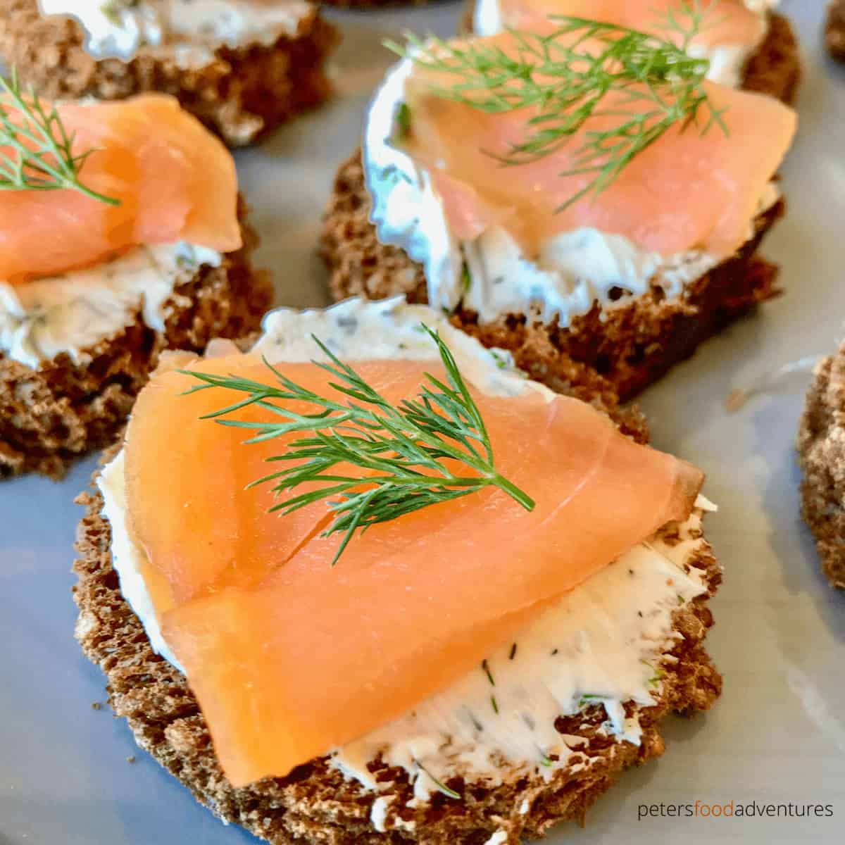 An easy to make appetizer, ready in minutes! Smoked Salmon, dill cream cheese on rye bread rounds (or pumpernickel). This simple 4 ingredients recipe is the perfect salmon canape for the holidays. Smoked Salmon Appetizers
