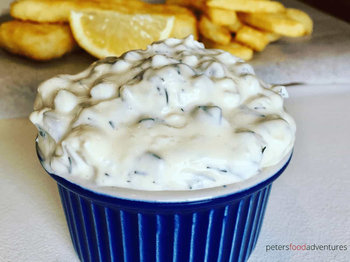 tartar sauce in a blue bowl beside fries