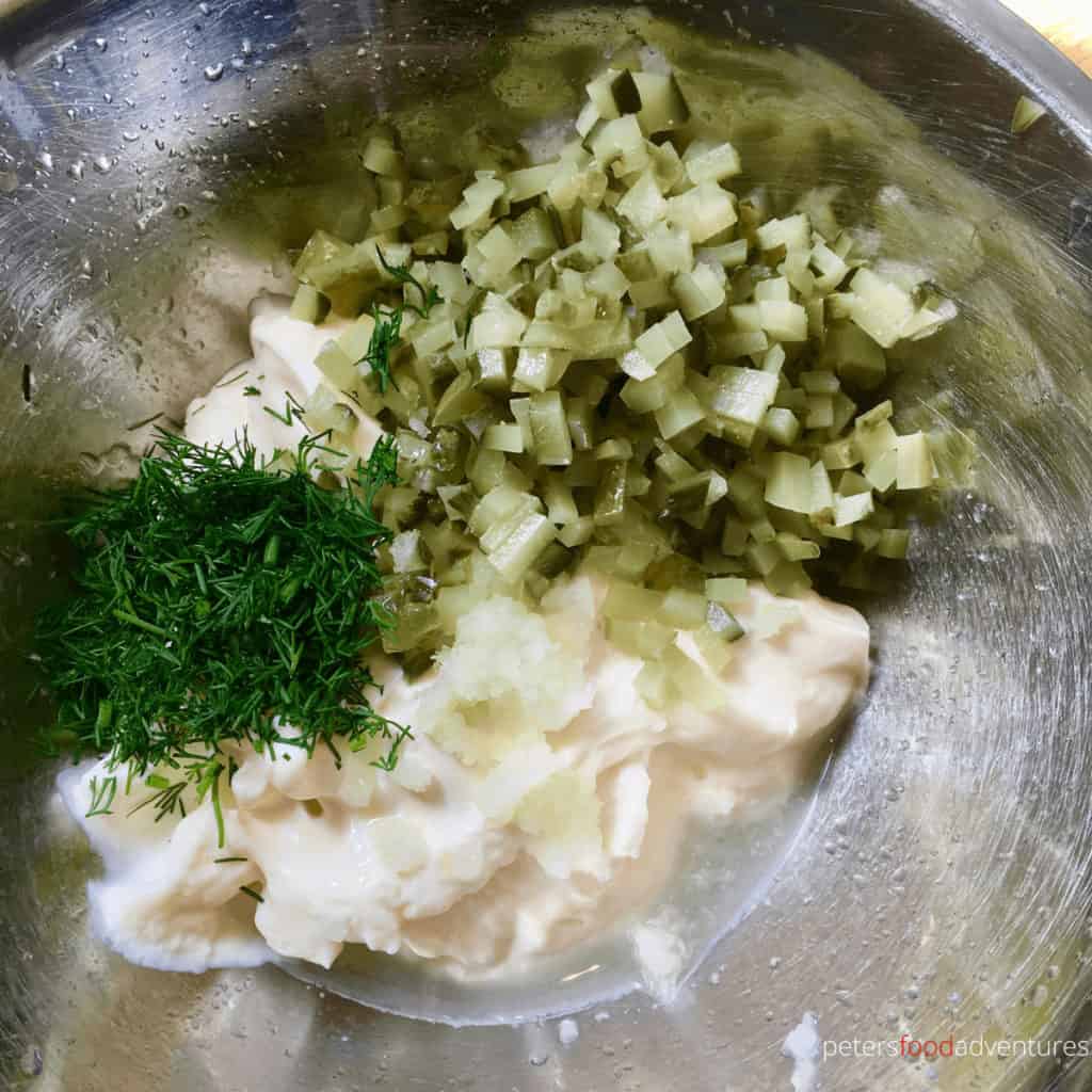 mixing homemade tartar sauce in a bowl with mayo