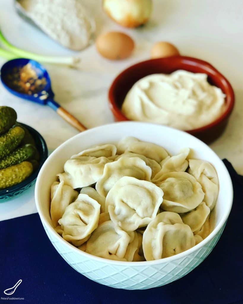 Pelmeni (Пельмени) are classic Russian dumplings that we all have in our freezer for an easy emergency meal. Step by step instructions make it easy to make. It takes some prep, we make hundreds, but it's worth the effort. Plus it saves you time later!