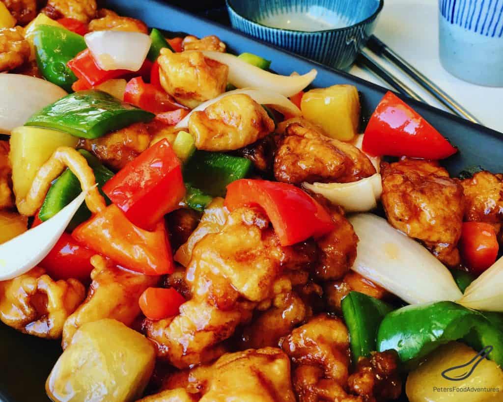 Boneless Sweet and Sour Pork in a crispy batter, food court style. The sauce is so easy to make with the sweetness of pineapple, bell peppers and onion. Tastes just like take out!