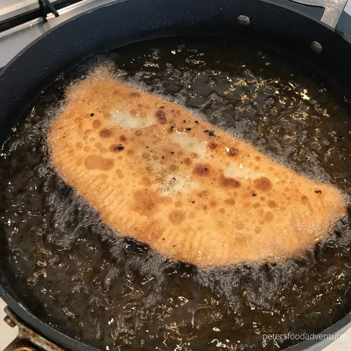 frying chebureki in oil