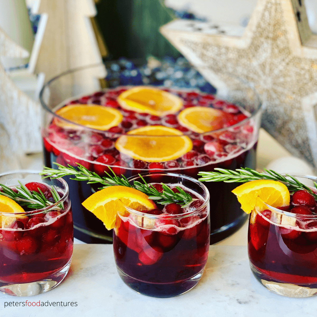 This Christmas Punch recipe with whole Cranberries is a tasty drink that's super easy to make, perfect for holiday parties. A non alcoholic cranberry party punch, the whole family can enjoy.