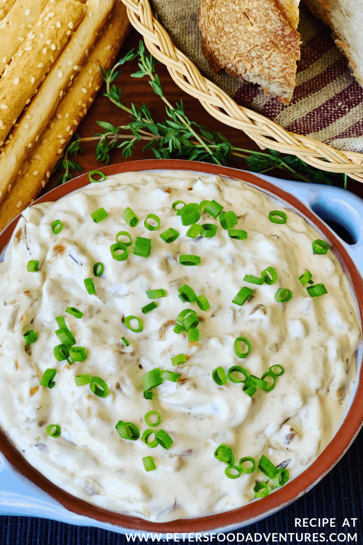 french onion dip in a bowl with breadsticks